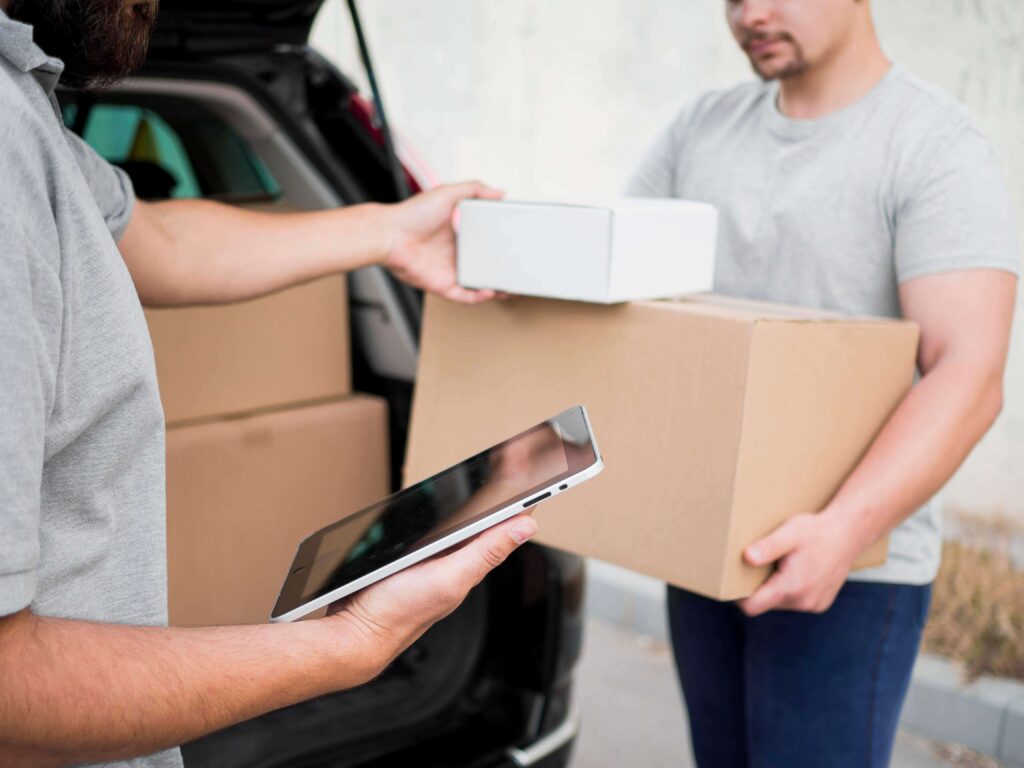 Delivery person handing over packages to a customer at the door, representing last-mile logistics and efficient courier services.