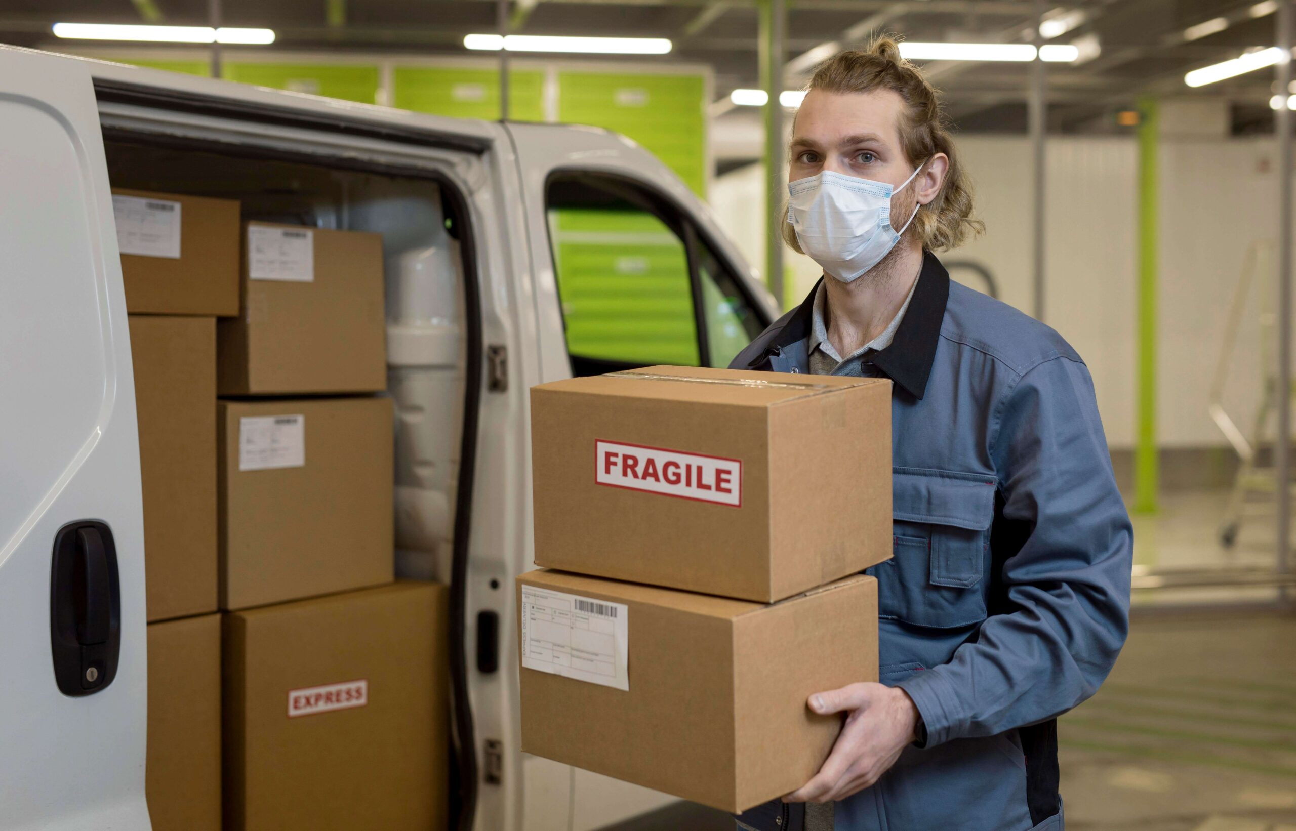 C4 Express delivery driver handling fragile medical packages, representing reliable last-mile delivery in healthcare logistics.